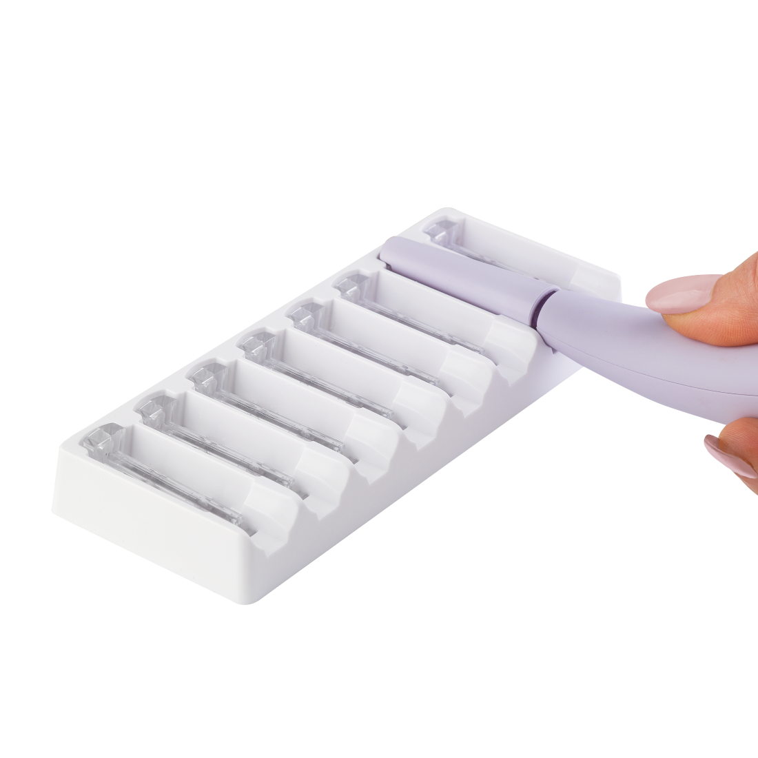 2 Month Supply - A hand places or removes the Michael Todd Beauty Sonicsmooth Pro+ Clear Refill Tips onto a white storage tray with six slots.